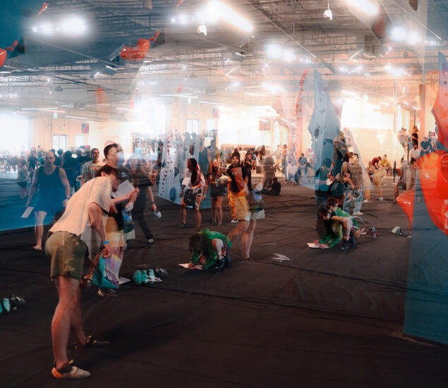 A busy indoor climbing gym in Tempe buzzes with energy as people prepare for Boulderfest 2025 on black mats. The double-exposure effect captures overlapping, ghost-like figures in this active, bright environment.